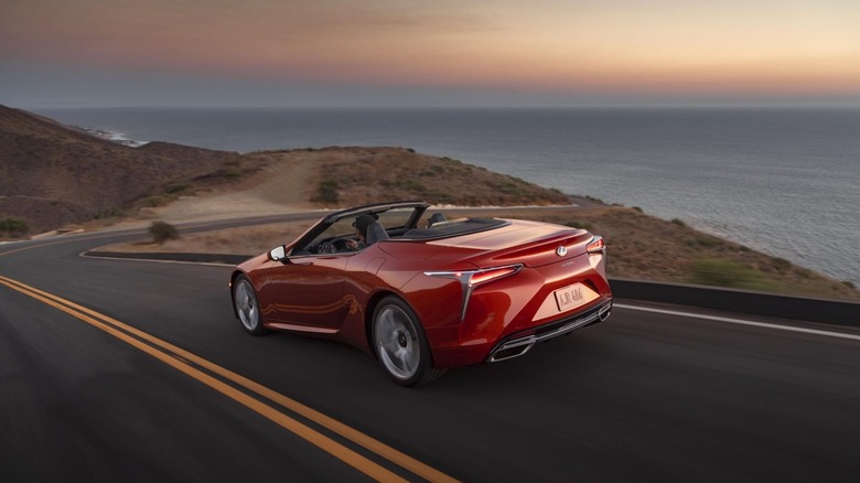 Lexus LC convertible driving on coastal road.
