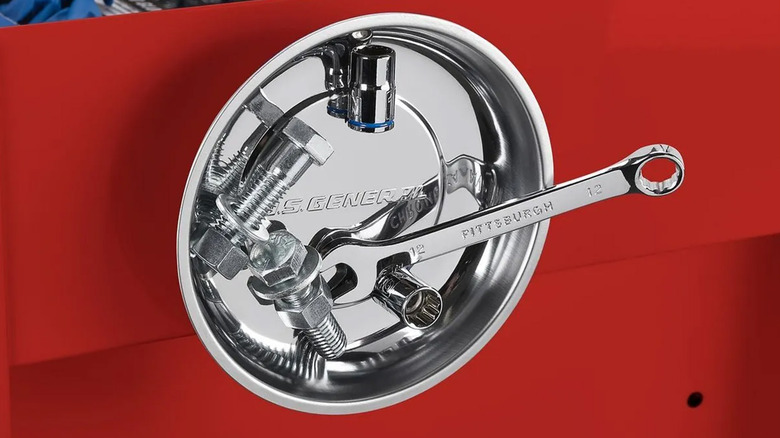 A magnetic parts dish attached to the side of a red toolbox