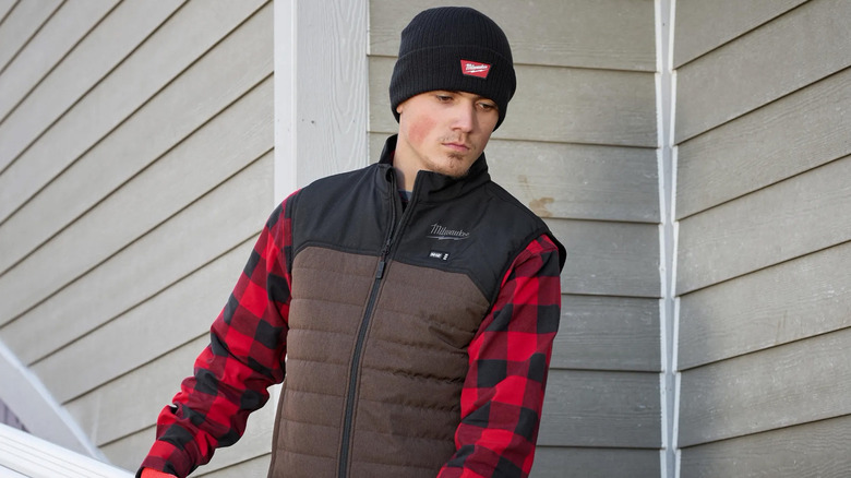 A man wearing an M12 Heated Axis vest from Milwaukee