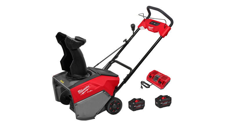 A Milwaukee snow blower with two batteries and a charger