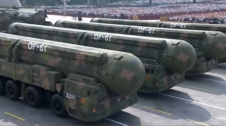 Four DF-61 road-going ballistic missile systems moving in formation as part of a parade.