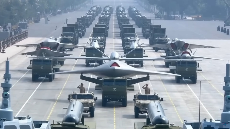 A grey GJ-21 drone, top view, mounted and displayed on a semi truck in a parade.