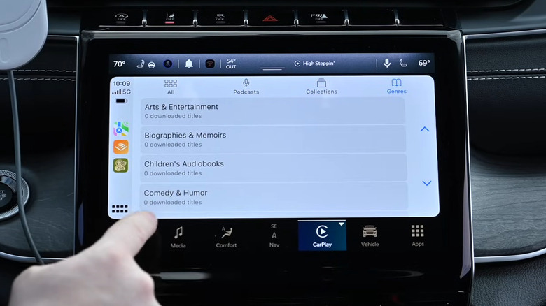 Person showing the interface of Audible app on Apple CarPlay