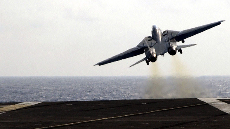 An F14 Tomcat taking off from the USS Theodore Roosevelt aircraft carrier