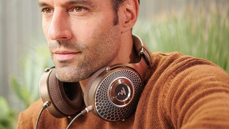 A man wearing the Focal Clear MG around his neck.