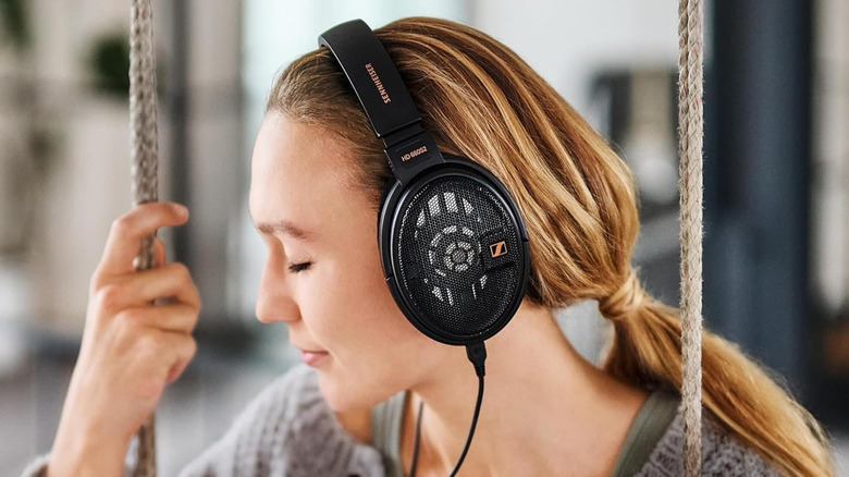 A woman listening to the Sennheiser HD 660S2 headphones.