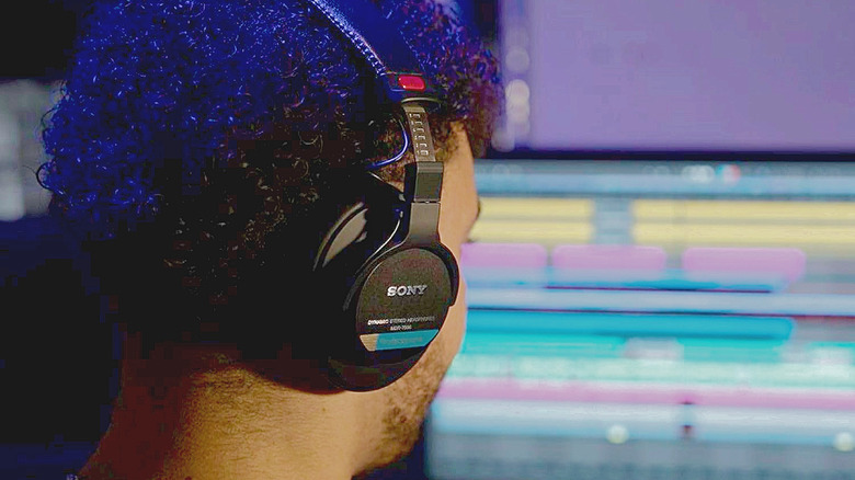 A man wearing the Sony MDR-7506 headphones in the studio.