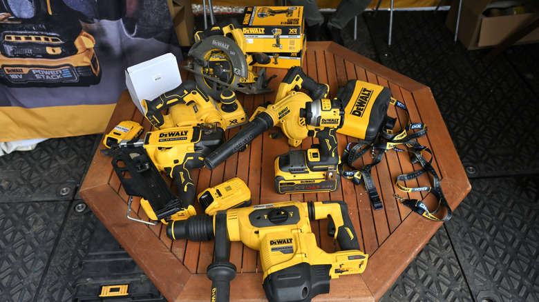 Multiple DeWalt tools on a wooden hexagonal table