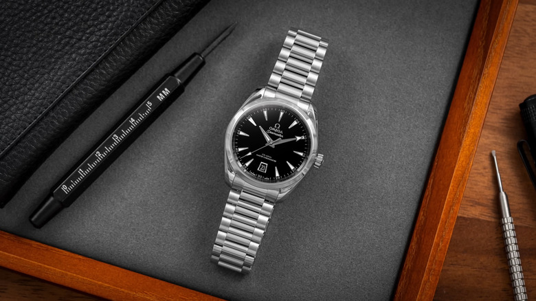 Omega Seamaster watch with adjustment tools