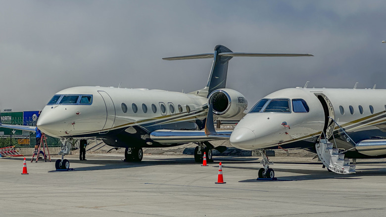 Two private jets parked in a private jet airport