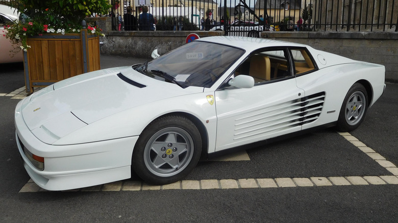 White Ferrari Testarossa supercar seen from left front parked on a street