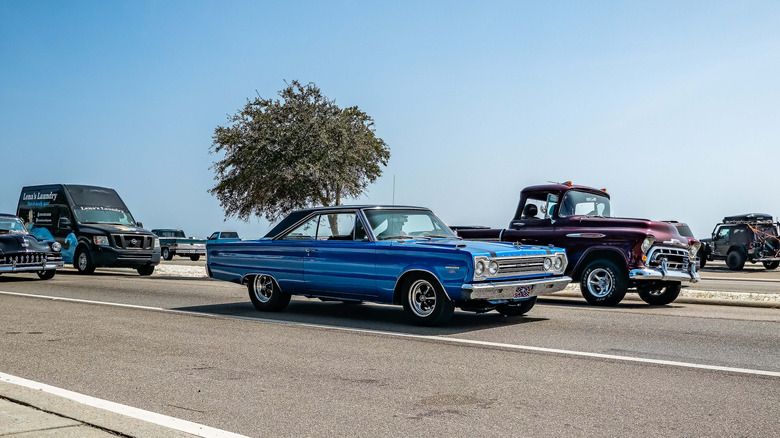 A wide-angle front-quarter-side view of a 1967 Plymouth Belvedere in blue.