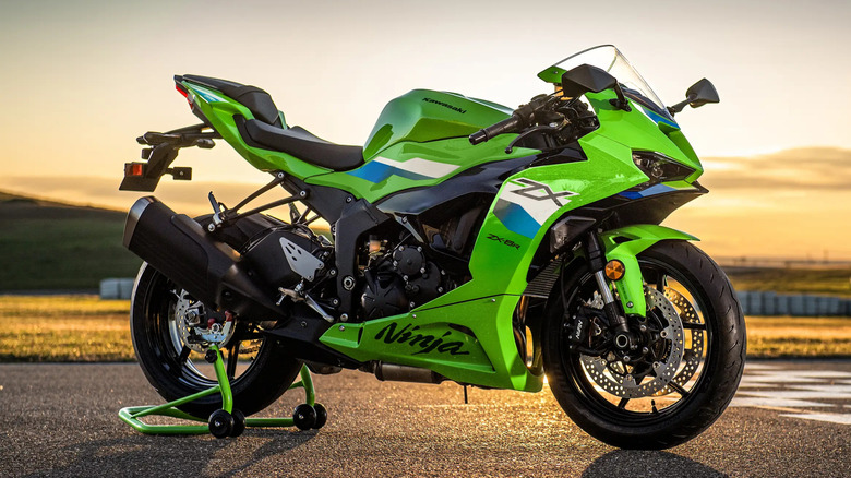 Green Kawasaki Ninja ZX-6R on a stand at sunset