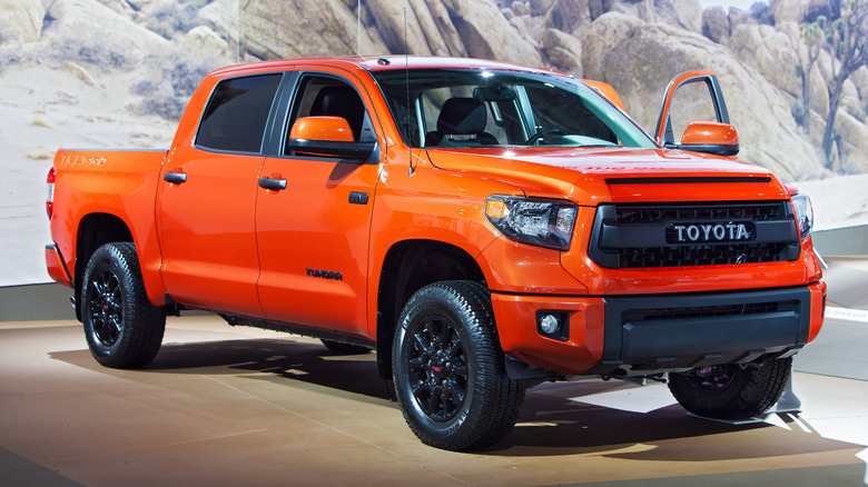 A side shot of an orange 2015 Toyota Tundra TRD Pro on display