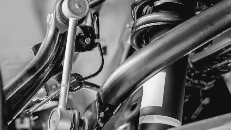 A sway bar link (left) in a vehicle suspension system