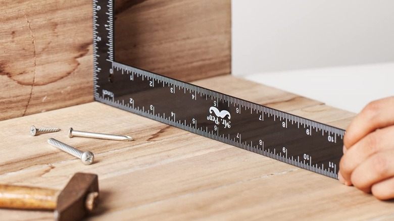 Person using carpenter's square