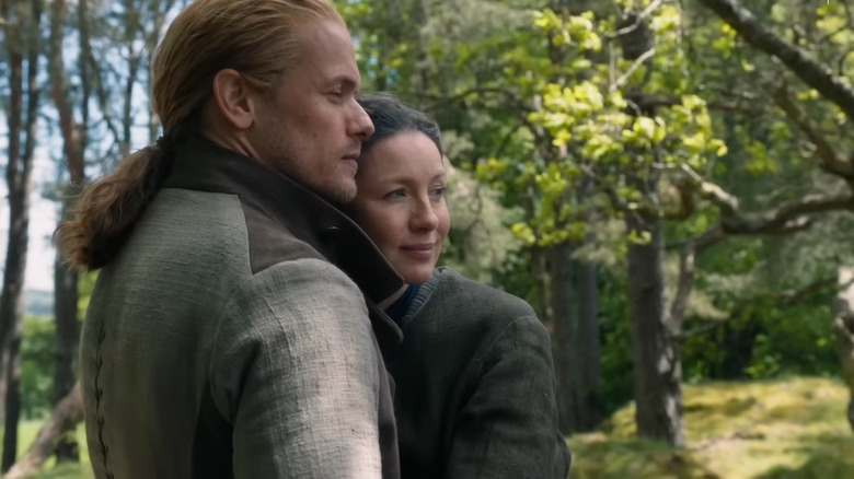 Outlander stars hugging in woods