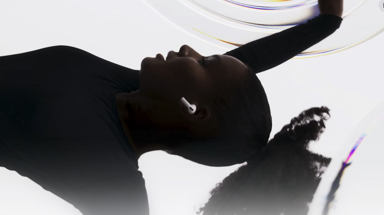 A woman dancing with a pair of AirPods Pro 3