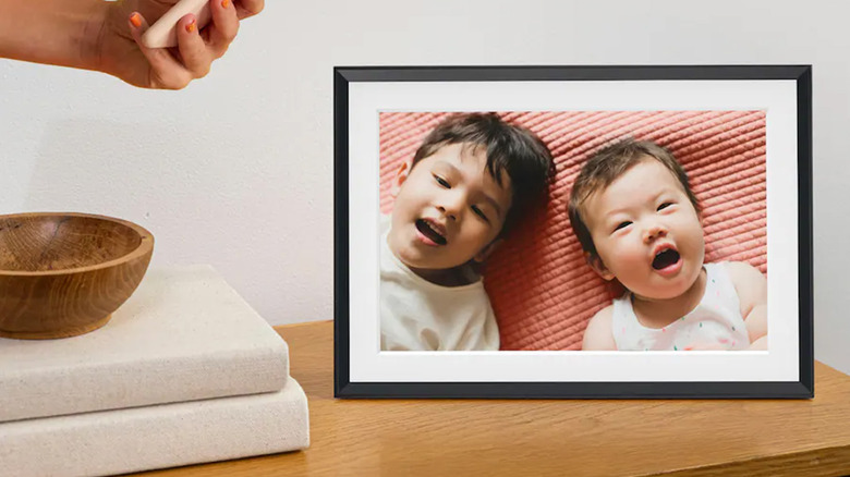 An Aura photo frame on a side table
