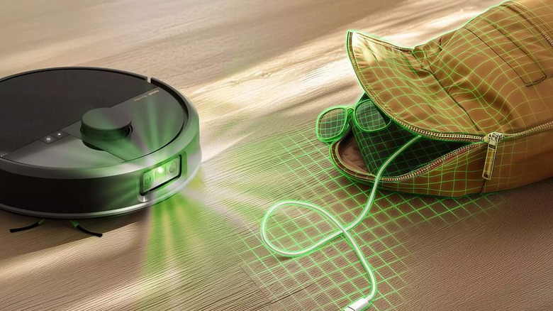 A Roomba sensing a purse and spilled items on the floor