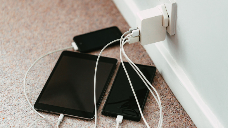 Multiple electronic devices plugged into a charger