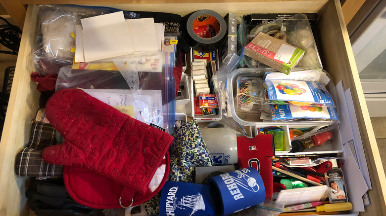 A junk drawer filled with various baubles