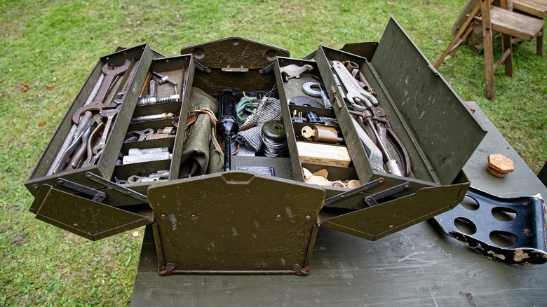 A World War II era toolbox with various tools
