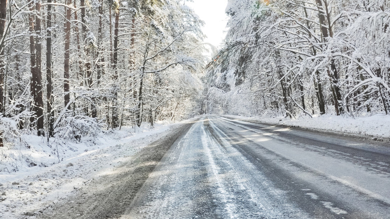 The sun reflects off an icy road in perfect black ice conditions