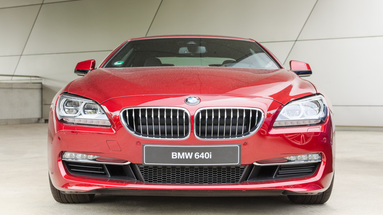 A red-colored 2014 BMW 640i displayed at an event, with the front-on view of the car being visible