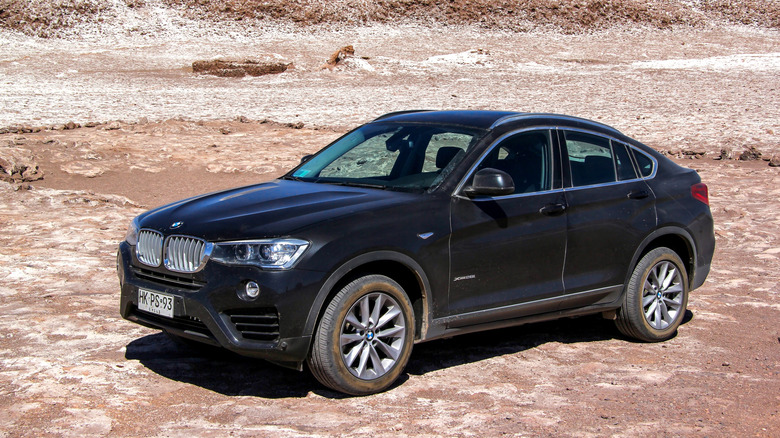 A new BMW F26 X4 parked, side view visible, on the Atacama desert salt plains