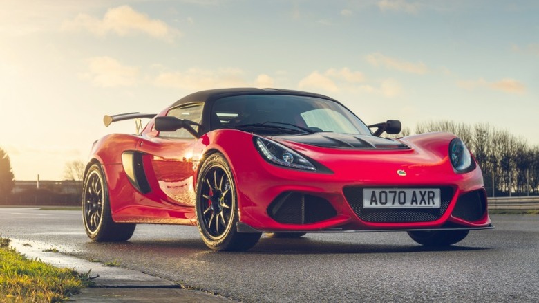 Red Lotus Exige Sport 430 Final Edition parked on a wet track at golden hour
