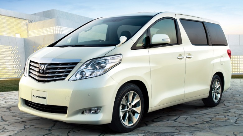 White Toyota Alphard in front of a building