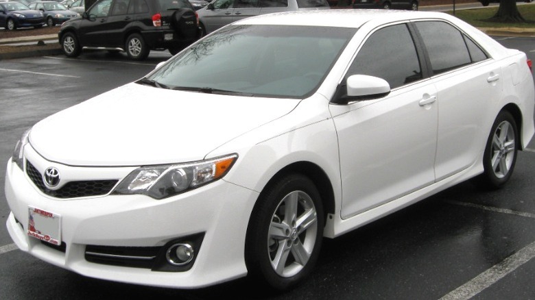 White 2012 Toyota Camry SE in a wet parking lot