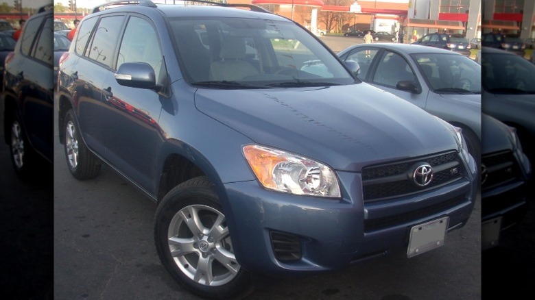 Blue 2009 Toyota RAV4 parked at a dealership