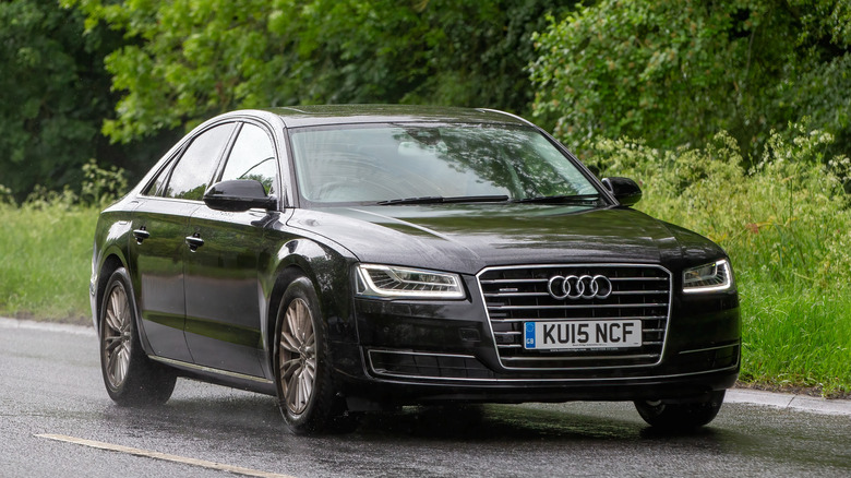 An Audi A8 driving on a road.
