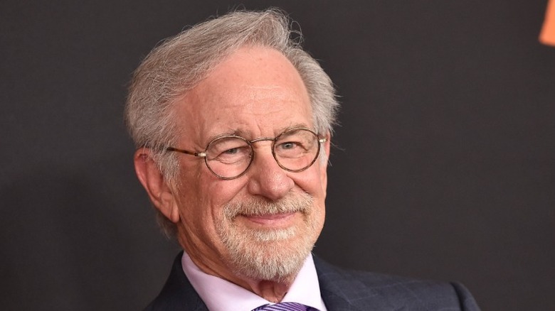 Steven Spielberg in a suit with a lilac tie