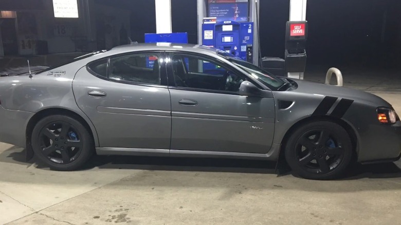 Grey Pontiac Grand Prix at a fuel station