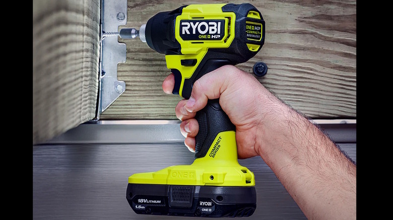 person installing corner brace with impact driver