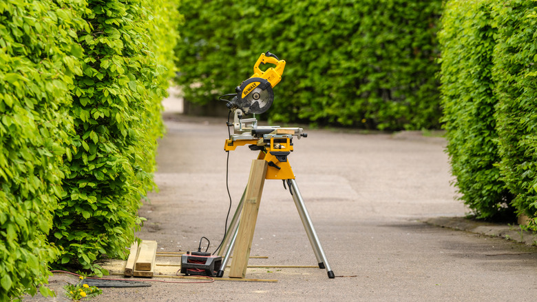 a DeWalt saw on a stand in a park