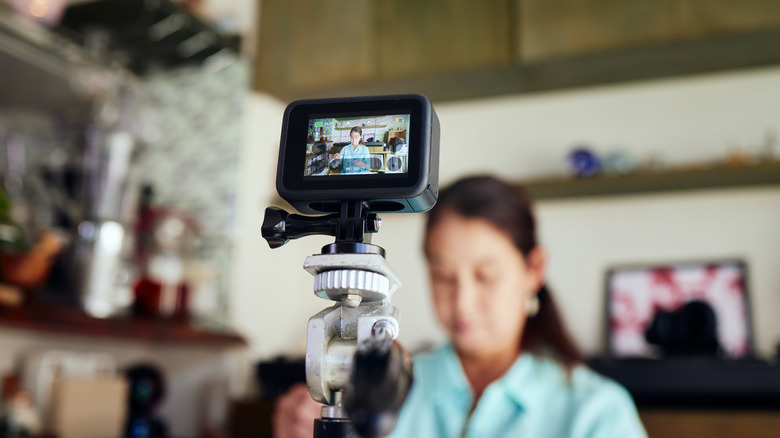 Blurred woman in front of a video camera