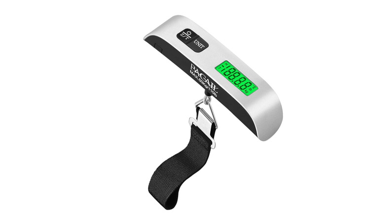 Digital luggage scale on white background