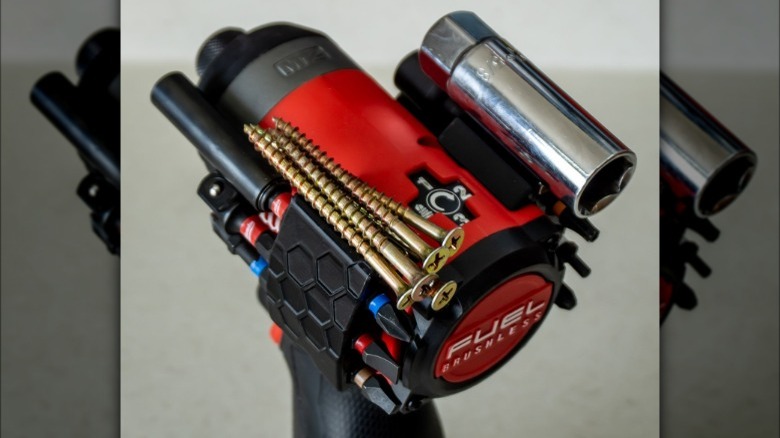 A Milwaukee M12 impact driver equipped with a 3D-printed magnetic bit holder on both sides.