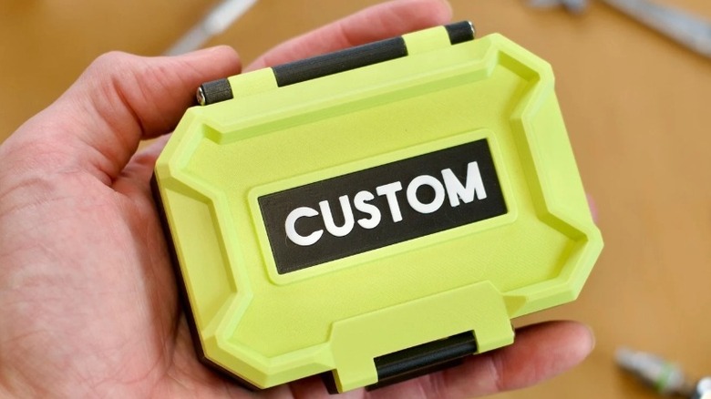 Green storage box in the palm of a hand