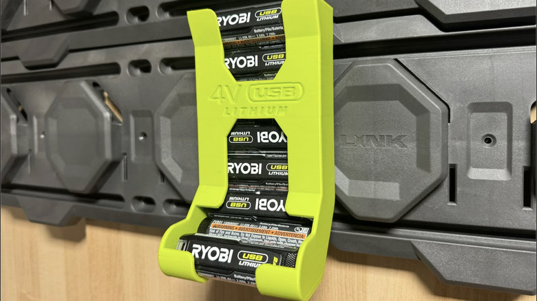 Green dispenser containing several batteries on a pegboard