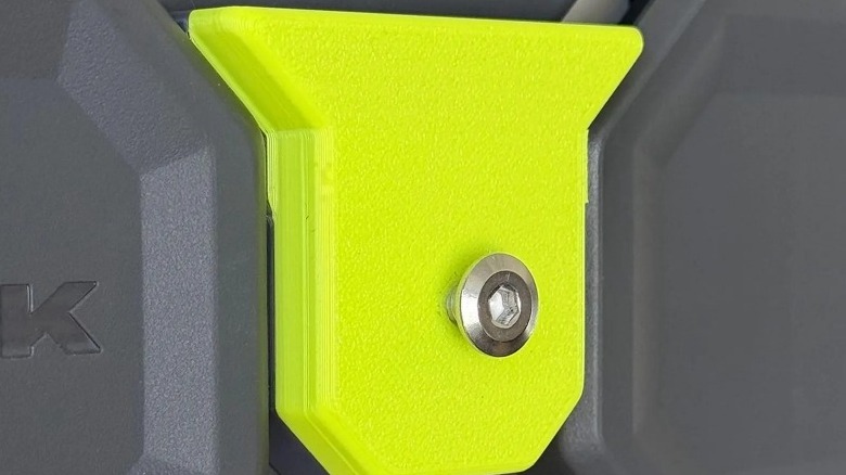 Green geometric hook on a black rail system