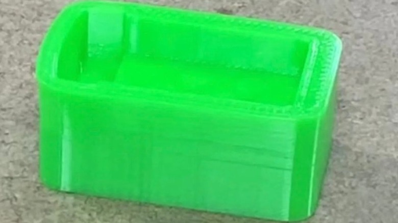Green rectangular device with a middle indention