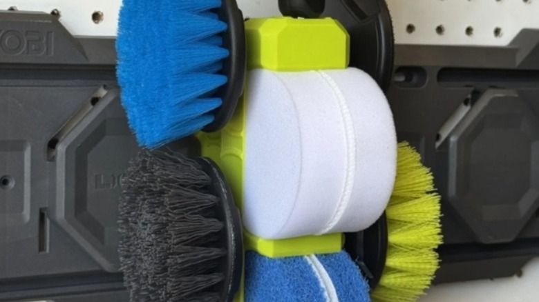 Collection of cleaning brushes mounted on a wall