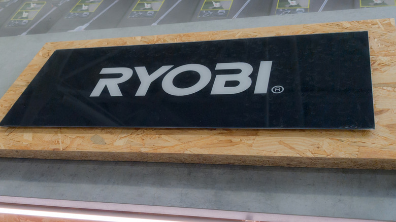 Ryobi sign in black on a piece of plywood