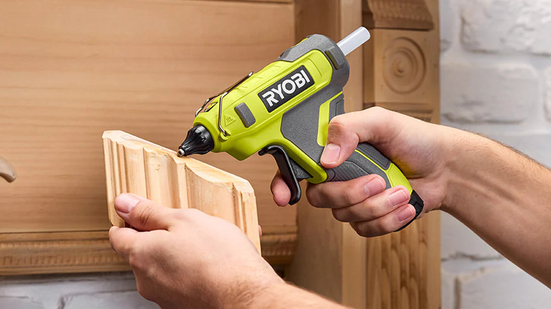 Using a Ryobi USB Lithium Glue Gun to attach trim
