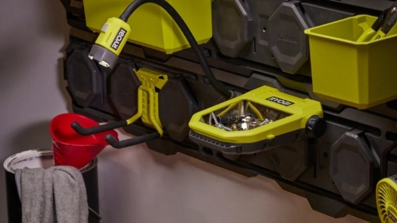 Green Ryobi-brand light and tray holding metal components